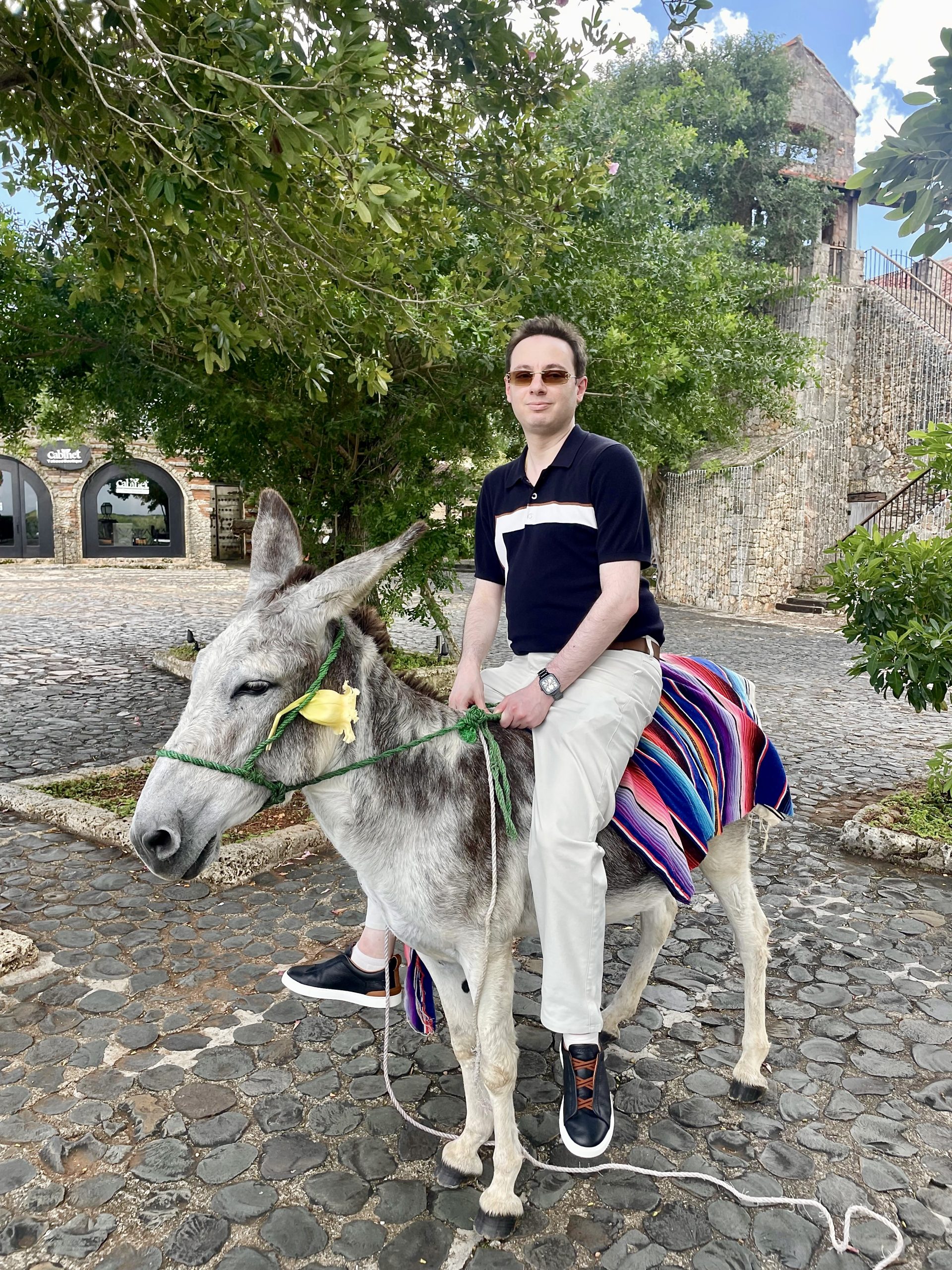 Patrick Diogenia riding a donkey while traveling